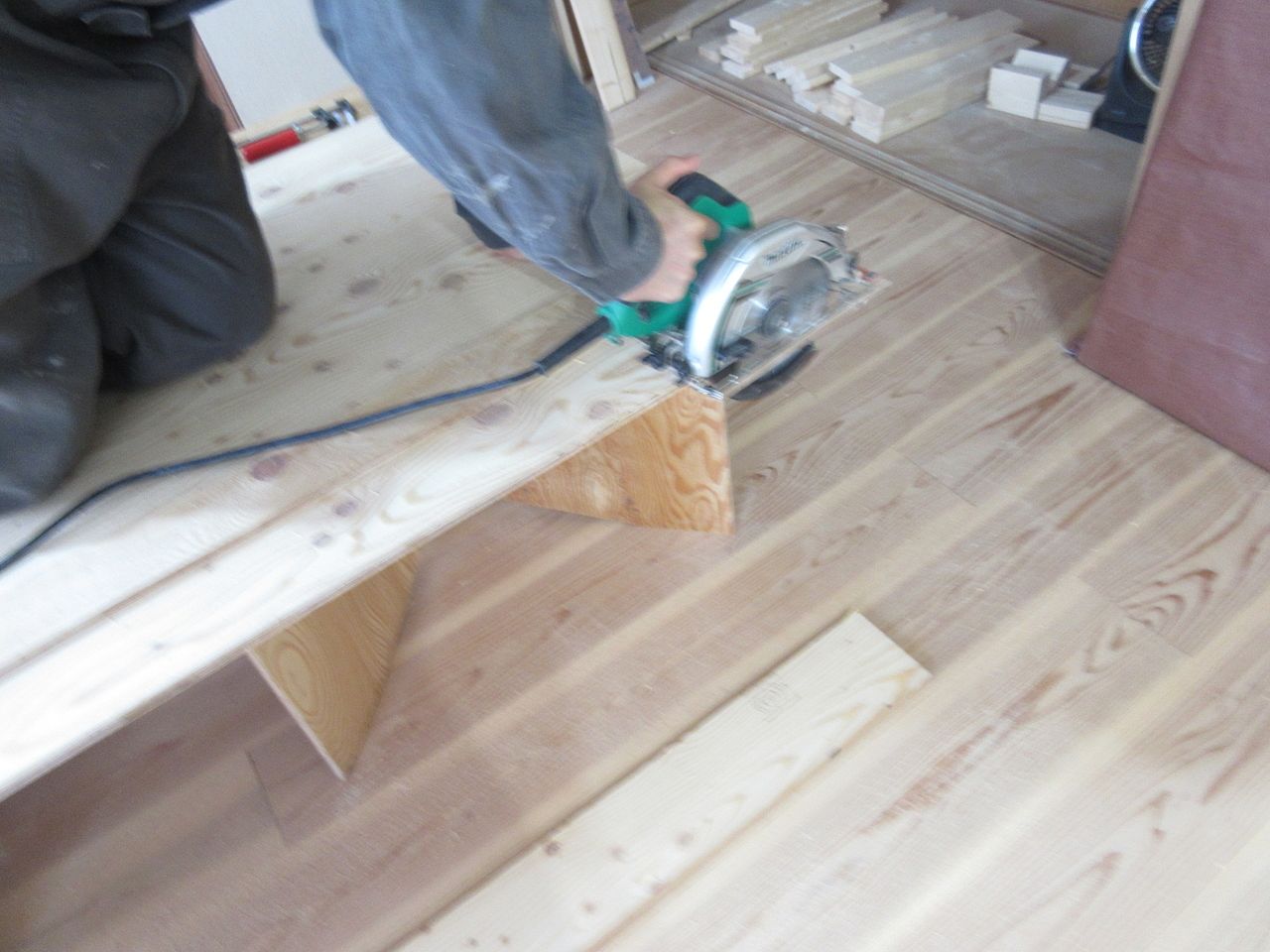 電動工具である丸ノコを使って合板をカットします。
そして、サンドペーパーを使って合板の角部分を磨いて削り落します。